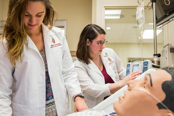 BSN students working with a simulation mannequin