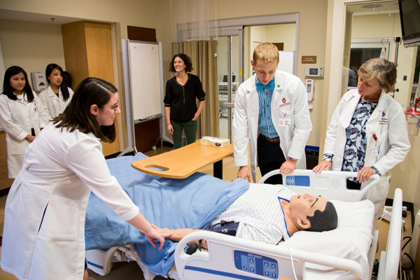 Photo of an Inter-Professional Education collaborative class with Nursing and Pharmacy students in a CTEN lab.