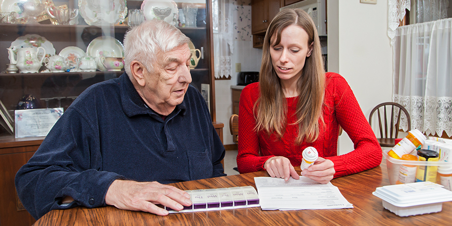 photo of Tonya Roberts working with an older adult in his home