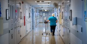 A Nurse walking down a hospital hallway with locks on the doors in the medical wing of the Dodge Correctional Institution.
