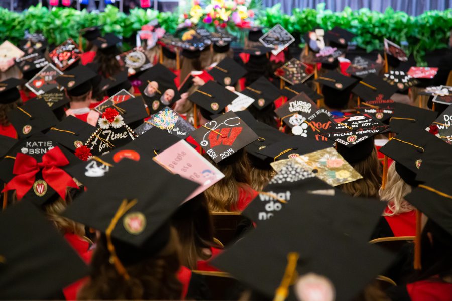 Graduates with decorated caps.