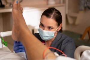 Courtney Maurer examines a patient
